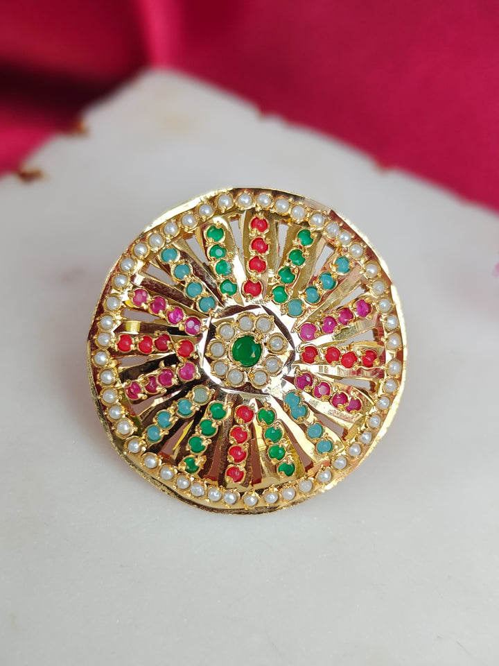 Close-up of an ornate traditional (Gold Polish) Multi-Color Ring with Colored Stone and Pearl. Mehendi function outfit styled with a lightweight Jadau Ring. Festive celebration look featuring a Jadau artificial Ring.