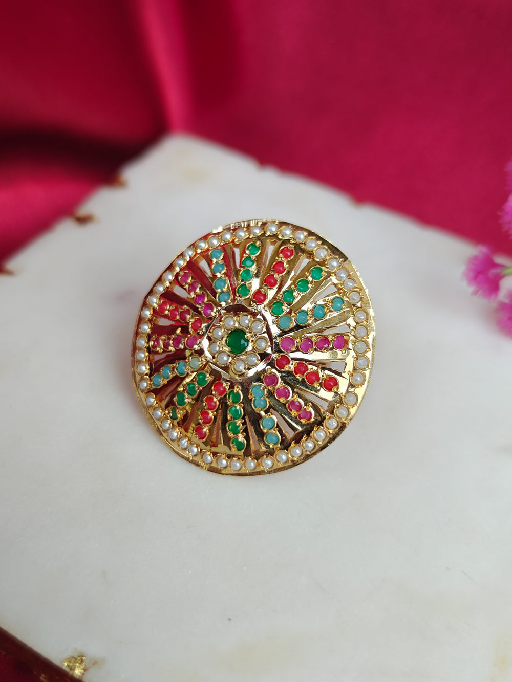 Close-up of an ornate traditional (Gold Polish) Multi-Color Ring with Colored Stone and Pearl. Mehendi function outfit styled with a lightweight Jadau Ring. Festive celebration look featuring a Jadau artificial Ring.