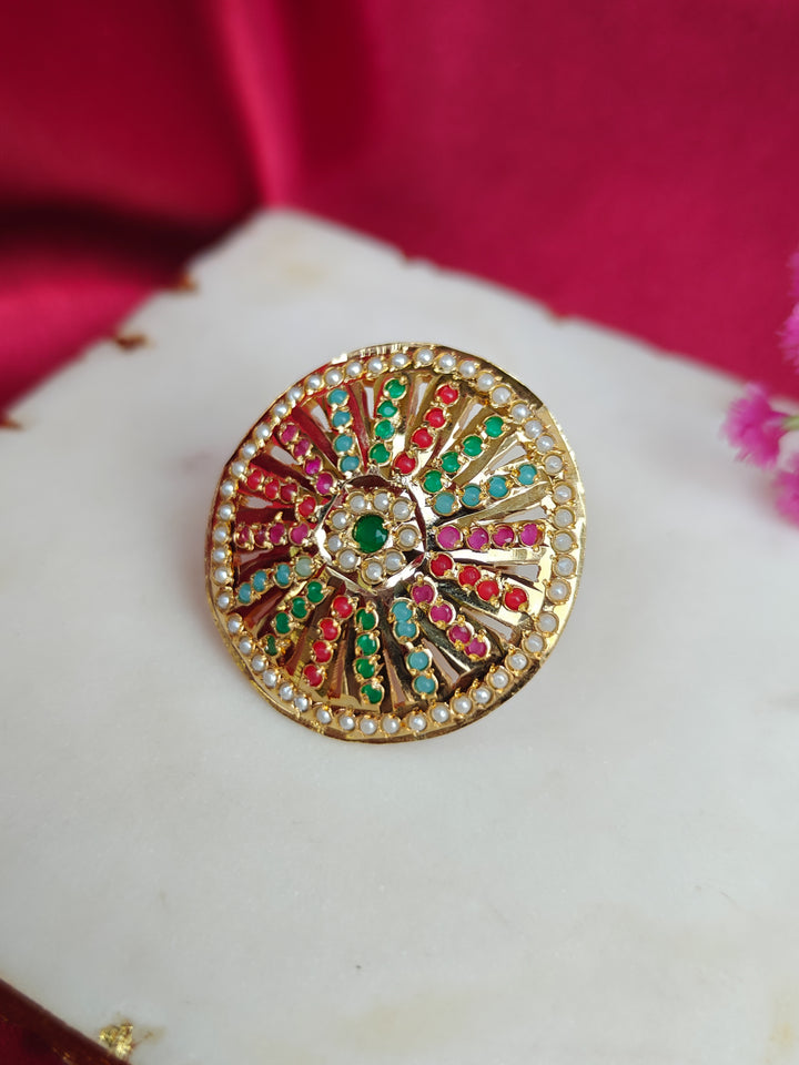 Close-up of an ornate traditional (Gold Polish) Multi-Color Ring with Colored Stone and Pearl. Mehendi function outfit styled with a lightweight Jadau Ring. Festive celebration look featuring a Jadau artificial Ring.