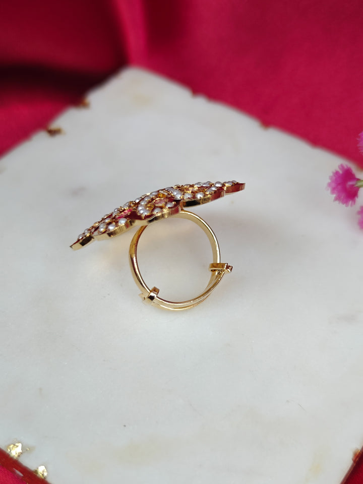 Close-up of an ornate traditional (Gold Polish) Multi-Color Ring with Colored Stone and Pearl. Mehendi function outfit styled with a lightweight Jadau Ring. Festive celebration look featuring a Jadau artificial Ring.