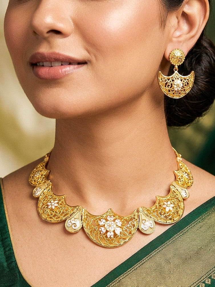 Close-up of a woman wearing an ornate traditional Meenakari gold Collar jewellery set and earrings with Filigree Work and Meenakari. Festive celebration look enhanced with traditional Meenakari jewelry. Close-up of detailed enamel craftsmanship in Meenakari jewelry.