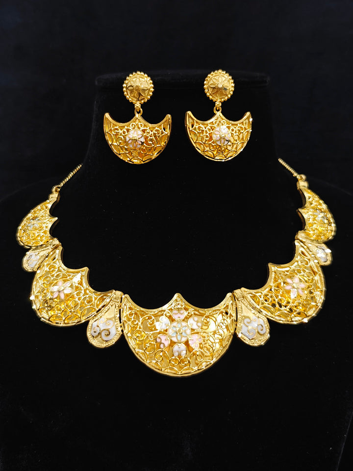 Close-up of an ornate traditional Meenakari gold Collar jewellery set and earrings with Filigree Work and Meenakari. Festive celebration look enhanced with traditional Meenakari jewelry. Close-up of detailed enamel craftsmanship in Meenakari jewelry.