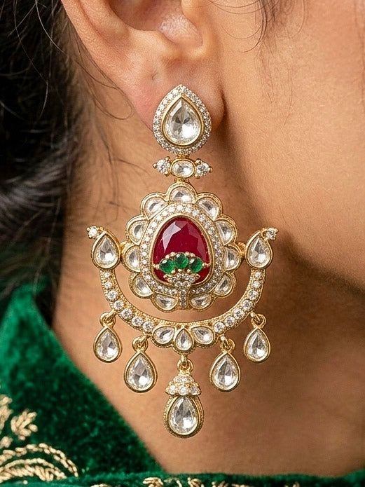 Close-up of a woman wearing an ornate traditional (Bright Gold) Red and Green Choker jewellery set and earrings and maangtikka with Uncut Kundan, American Diamond, Green Colored Stones, Pearls and Doublet Stone. Bride showcasing a premium imitation Moissanite jewelry set for her reception look. Wedding celebration styling with a luxury artificial Moissanite jewelry Set design.