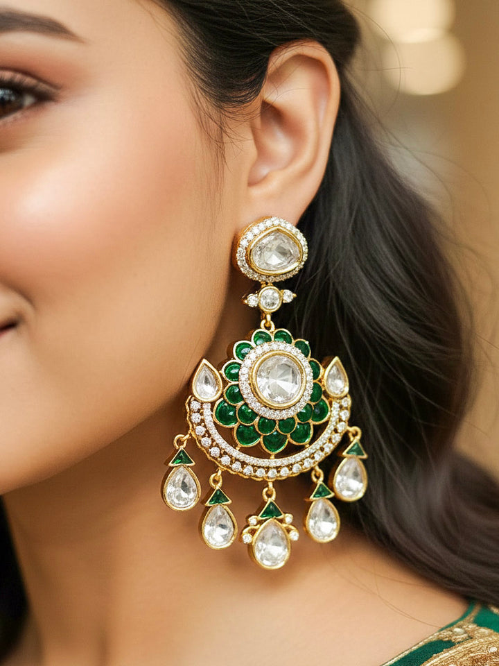 Close-up of a woman wearing an ornate traditional (Bright Gold) Green Collar jewellery set and earrings and maangtikka with Green Colored Stones, American Diamond, Pearls and Moissanite. Reception night styling featuring sparkling imitation Moissanite jewelry Set. Bride wearing a high-quality artificial Moissanite jewelry set for wedding rituals.