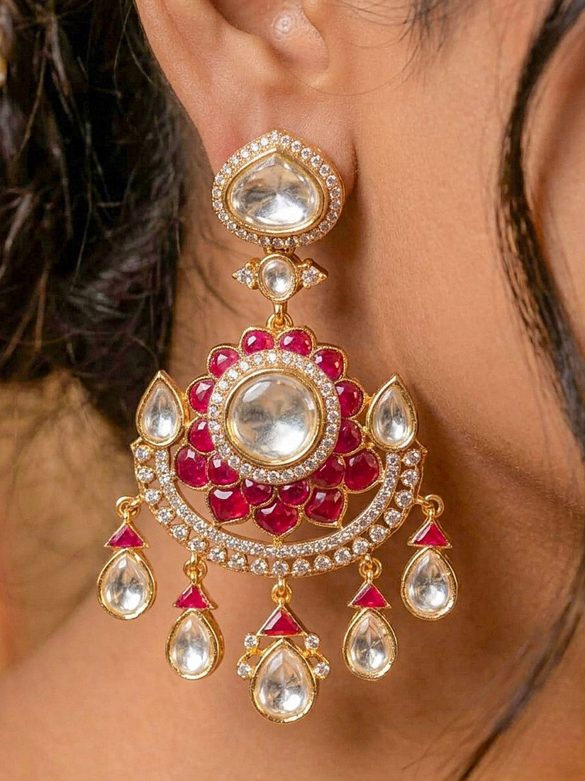 Close-up of a woman wearing an ornate traditional (Bright Gold) Red Collar jewellery set and earrings and maangtikka with Red Colored Stones, American Diamond, Pearls and Moissanite. Reception night styling featuring sparkling imitation Moissanite jewelry Set. Bride wearing a high-quality artificial Moissanite jewelry set for wedding rituals.