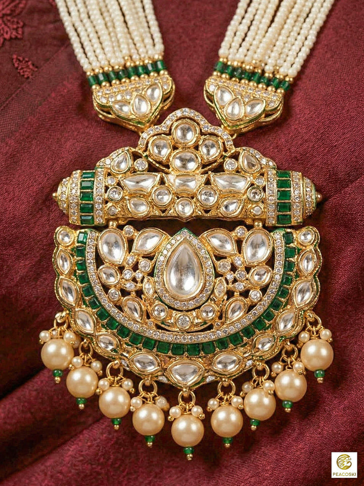 Close-up of a woman wearing an ornate traditional (Bright Gold) Green long jewellery set and earrings with Moissanite Polki, American Diamond, Green Colored Stones, Pearls, Beads and Hydro Crystals. Woman wearing Long artificial Moissanite jewelry for a grand celebration. Bride wearing a high-quality artificial Moissanite jewelry set for wedding rituals.