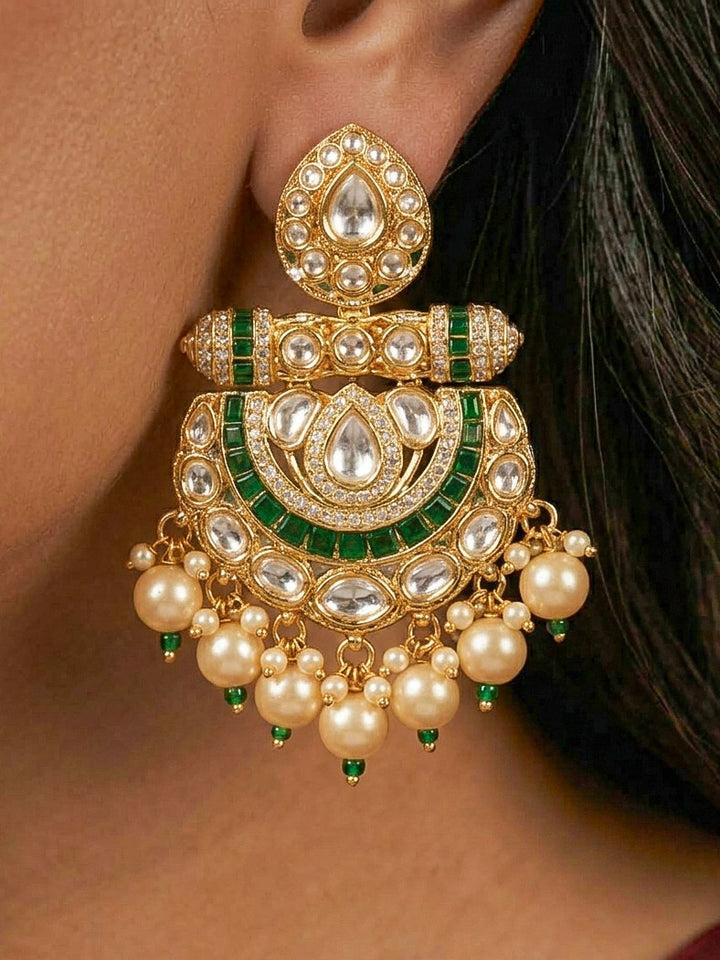Close-up of a woman wearing an ornate traditional (Bright Gold) Green long jewellery set and earrings with Moissanite Polki, American Diamond, Green Colored Stones, Pearls, Beads and Hydro Crystals. Woman wearing Long artificial Moissanite jewelry for a grand celebration. Bride wearing a high-quality artificial Moissanite jewelry set for wedding rituals.
