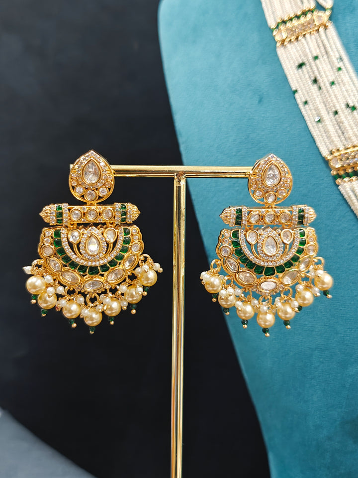 Close-up of an ornate traditional (Bright Gold) Green long jewellery set and earrings with Moissanite Polki, American Diamond, Green Colored Stones, Pearls, Beads and Hydro Crystals. Woman wearing Long artificial Moissanite jewelry for a grand celebration. Bride wearing a high-quality artificial Moissanite jewelry set for wedding rituals.