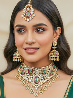 Close-up of a woman wearing an ornate traditional (Bright Gold) Mint Green and Ruby Pink Choker jewellery set and earrings and maangtikka with Doublet Stone, Moissanite, Kundan, American Diamond and Ruby Pink & Mint Green colored Stone. Bridal photoshoot look styled with a luxury imitation Moissanite jewelry set. Bride showcasing a traditional yet modern artificial Moissanite jewelry set design.