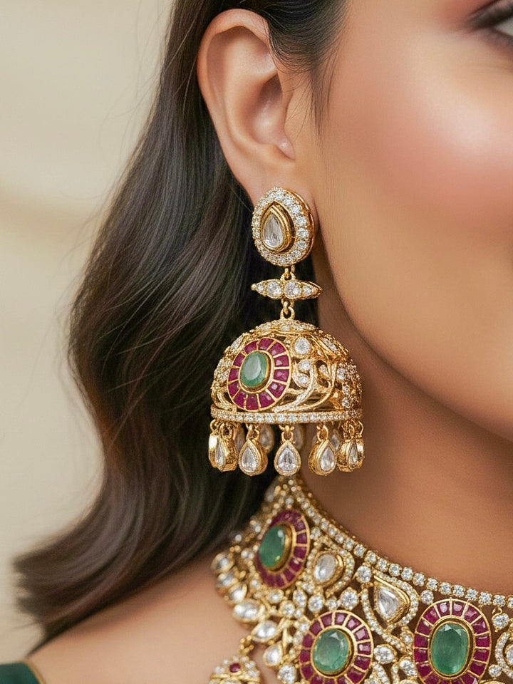Close-up of a woman wearing an ornate traditional (Bright Gold) Mint Green and Ruby Pink Choker jewellery set and earrings and maangtikka with Doublet Stone, Moissanite, Kundan, American Diamond and Ruby Pink & Mint Green colored Stone. Bridal photoshoot look styled with a luxury imitation Moissanite jewelry set. Bride showcasing a traditional yet modern artificial Moissanite jewelry set design.