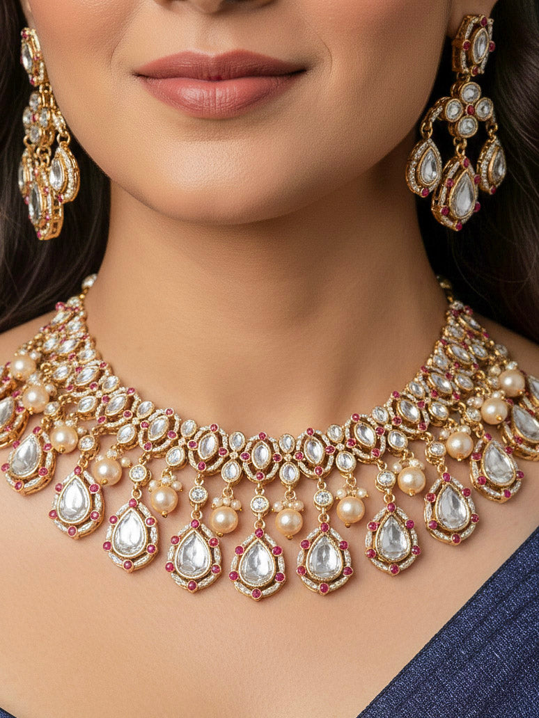 Close-up of a woman wearing an ornate traditional (Bright Gold) Pink Collar jewellery set and earrings and maangtikka with Kundan, Pink Colored Stones, American Diamond and Pearls. Bridal photoshoot look styled with a luxury imitation Moissanite jewelry set. Woman wearing Luxury artificial Moissanite jewelry for a grand celebration.