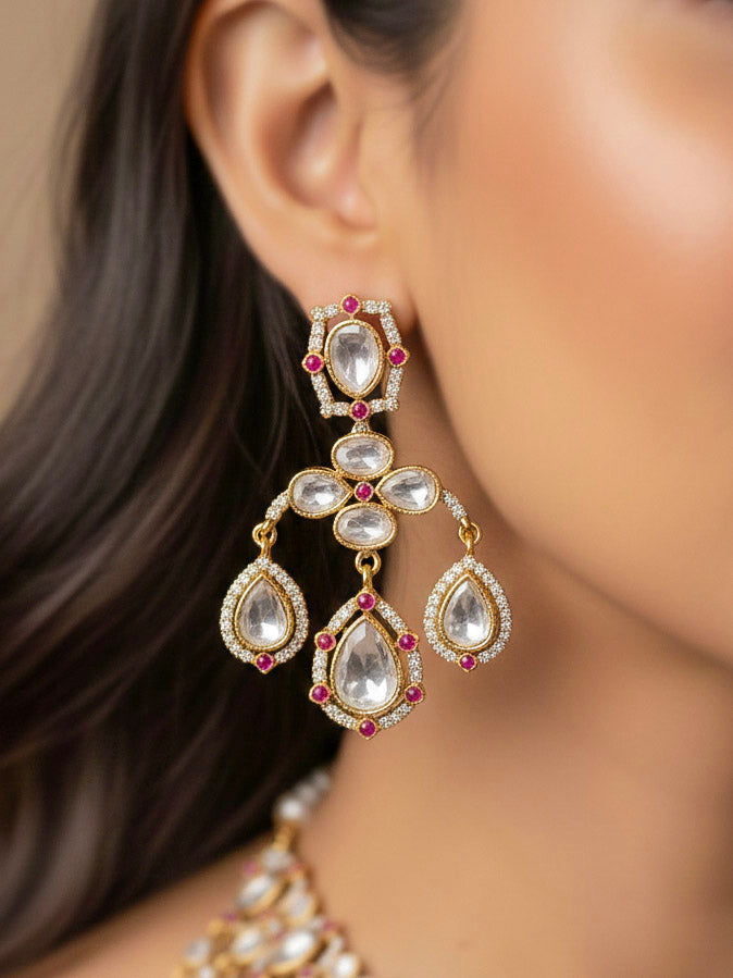 Close-up of a woman wearing an ornate traditional (Bright Gold) Pink Collar jewellery set and earrings and maangtikka with Kundan, Pink Colored Stones, American Diamond and Pearls. Bridal photoshoot look styled with a luxury imitation Moissanite jewelry set. Woman wearing Luxury artificial Moissanite jewelry for a grand celebration.