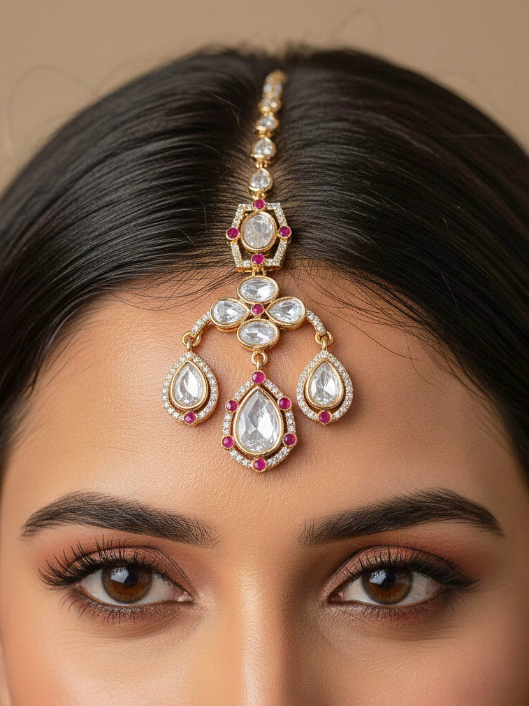 Close-up of a woman wearing an ornate traditional (Bright Gold) Pink Collar jewellery set and earrings and maangtikka with Kundan, Pink Colored Stones, American Diamond and Pearls. Bridal photoshoot look styled with a luxury imitation Moissanite jewelry set. Woman wearing Luxury artificial Moissanite jewelry for a grand celebration.