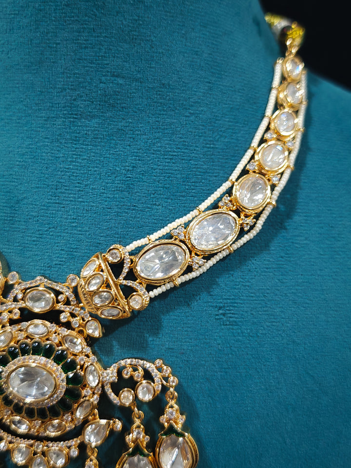 Close-up of an ornate traditional (Bright Gold) Green Collar jewellery set and earrings and maangtikka with Green Colored Stones, Kundan, American Diamond and Pearls. Woman wearing trending artificial Moissanite jewelry for wedding season in India. Bride wearing a high-quality artificial Moissanite jewelry set for wedding rituals.