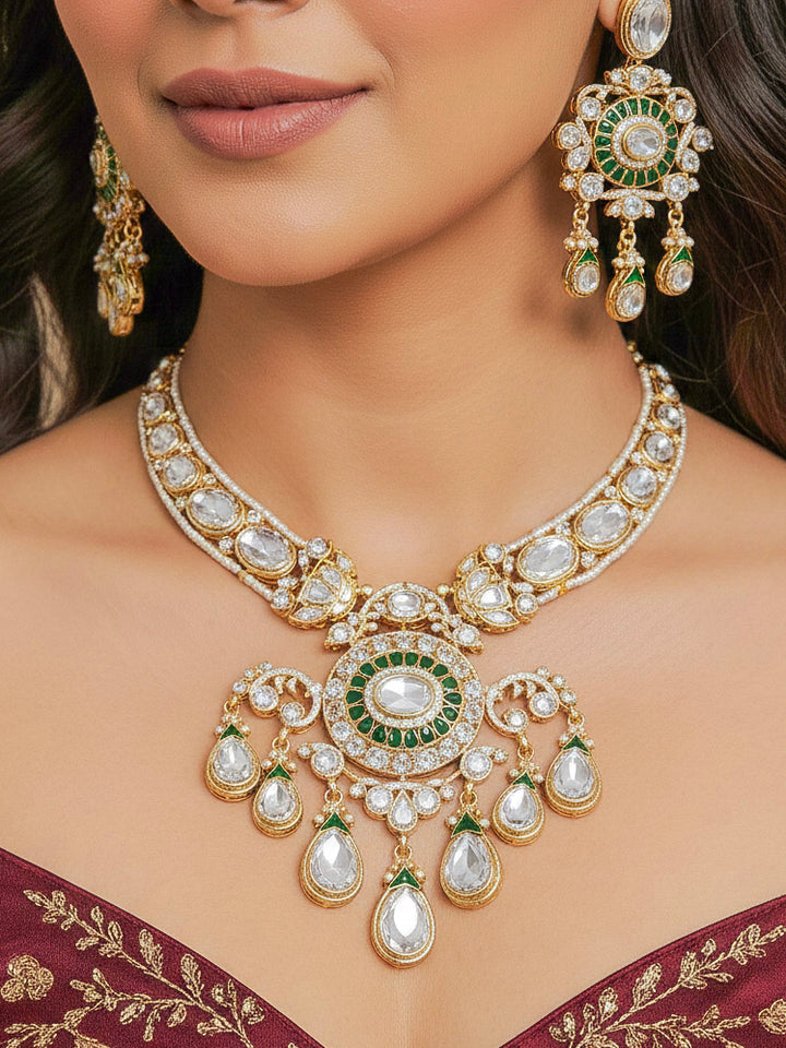Close-up of a woman wearing an ornate traditional (Bright Gold) Green Collar jewellery set and earrings and maangtikka with Green Colored Stones, Kundan, American Diamond and Pearls. Woman wearing trending artificial Moissanite jewelry for wedding season in India. Bride wearing a high-quality artificial Moissanite jewelry set for wedding rituals.