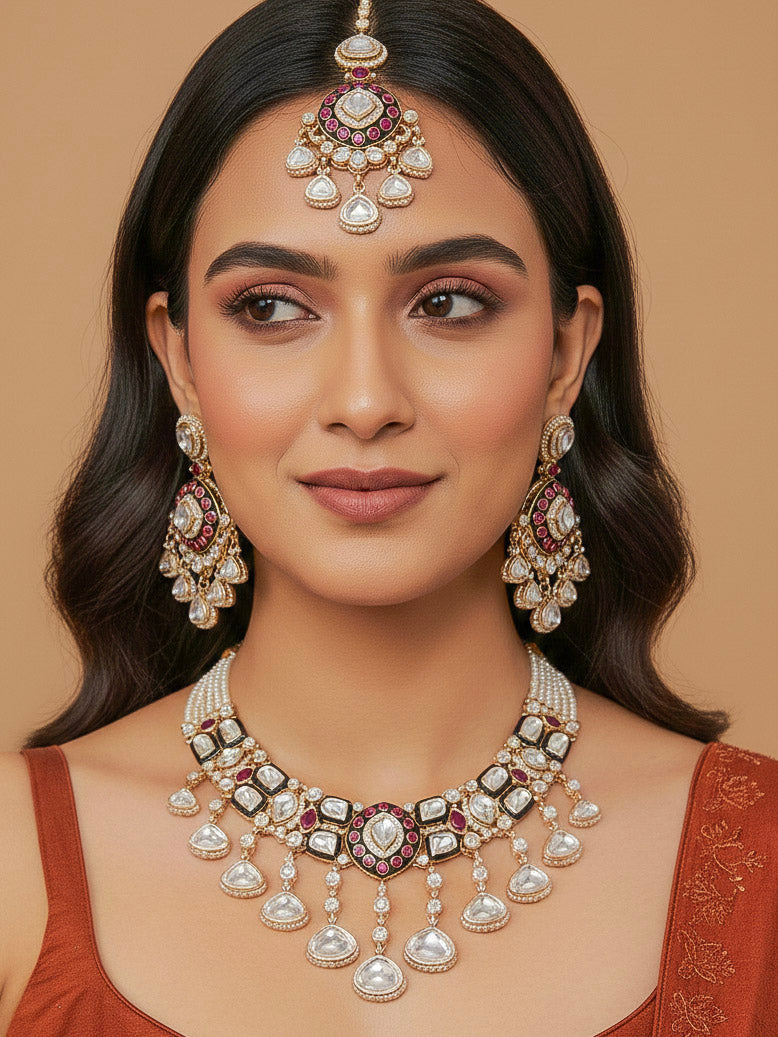 Close-up of a woman wearing an ornate traditional Meenakari Green and Pink Collar jewellery set and earrings and maangtikka with Pink Colored Stones, Uncut Kundan, American Diamond and Meenakari. Bride wearing a colorful Meenakari artificial necklace set for her wedding ceremony. Close-up of intricate Meenakari detailing in imitation bridal jewelry.