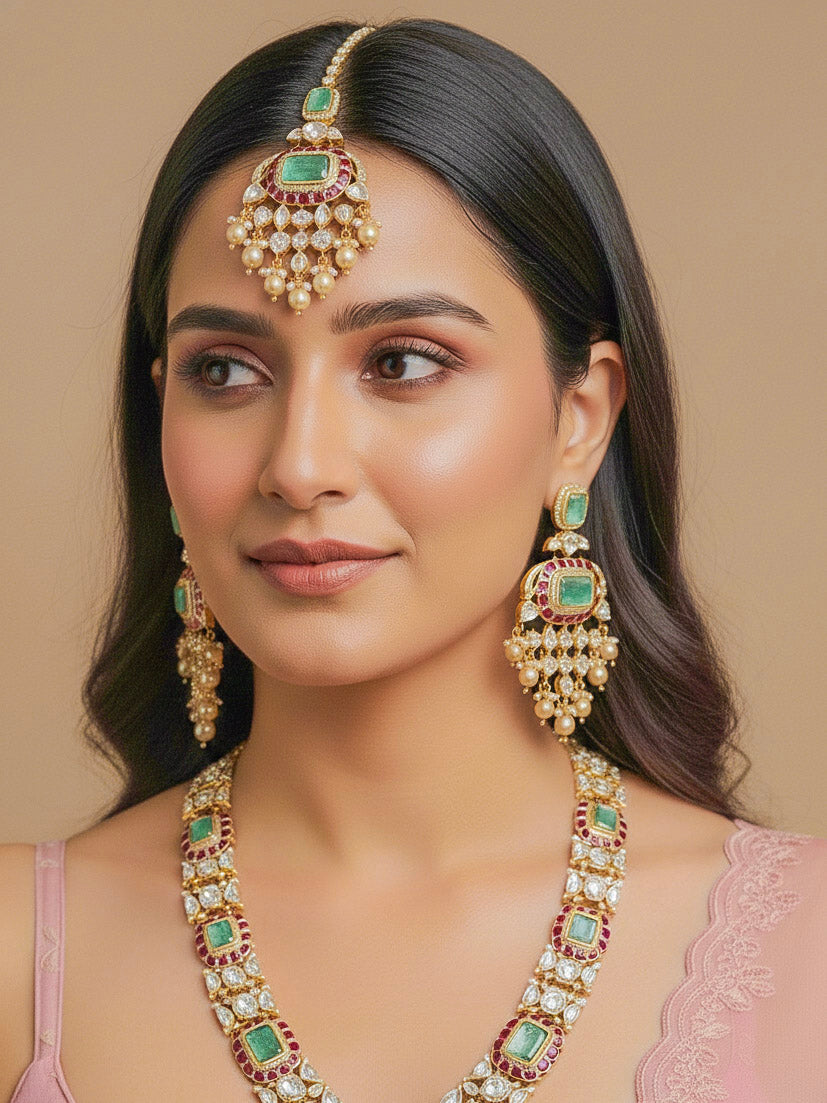 Close-up of a woman wearing an ornate traditional (Bright Gold) Mint Green and Ruby Pink jewellery set and earrings and maangtikka with American Diamond, Pink Colored Stones, Uncut Kundan, Pearls and Doublet Stone. Bride showcasing a premium imitation Moissanite  jewelry set for her reception look. Elegant Indian wedding look completed with luxury artificial  moissanite jewelry set. 