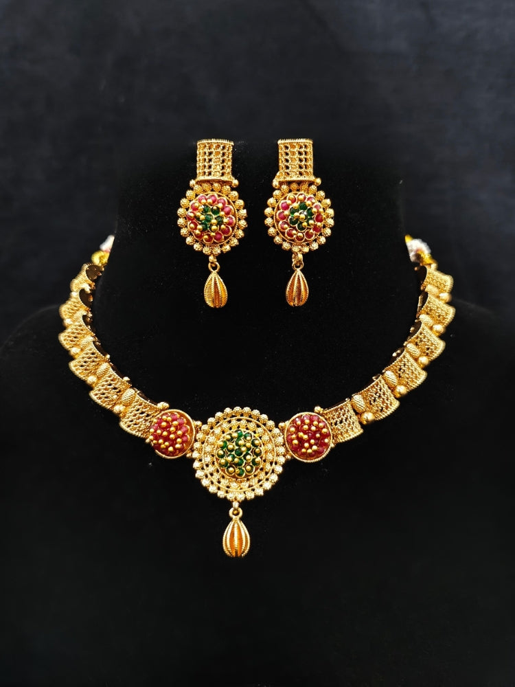Close-up of an ornate traditional (Gold Polish) Collar jewellery set and earrings with Crystal Beads. Woman wearing trending artificial Colored Stone jewelry for wedding season in India. Saree look completed with elegant artificial Colored Stone jewelry for festive occasions.