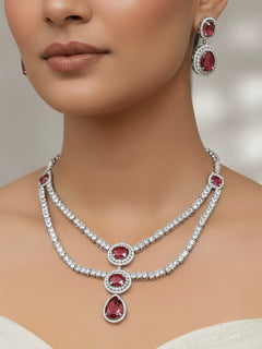 Woman wearing the Twila two-layer American Diamond necklace set with red stone centre