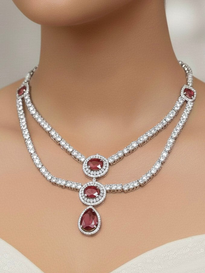 "A close-up shot of a bride wearing a stunning artificial diamond necklace with red colored stone with matching earrings, designed to complement bridal attire. This affordable diamond necklace set is perfect for brides seeking luxurious but cost-effective wedding jewelry in India."

