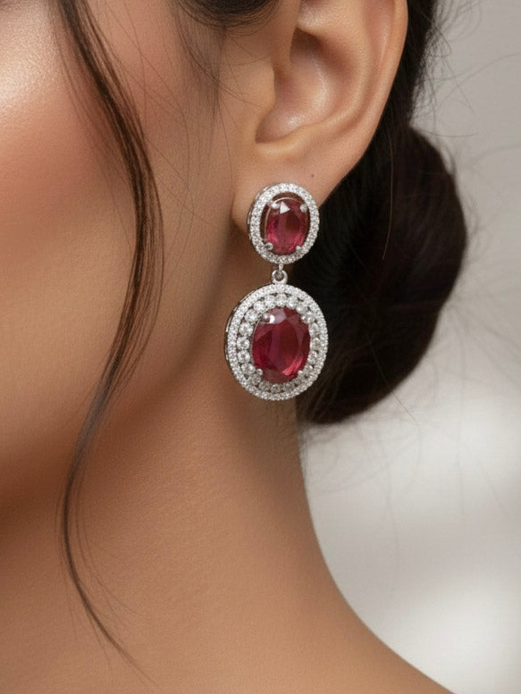 "A stunning woman wearing a glamorous artificial diamond necklace with red colored stone paired with chic earrings, perfect for bridal wear. This high-quality artificial diamond jewelry set is the ideal choice for modern brides looking for a budget-friendly option with timeless sparkle."