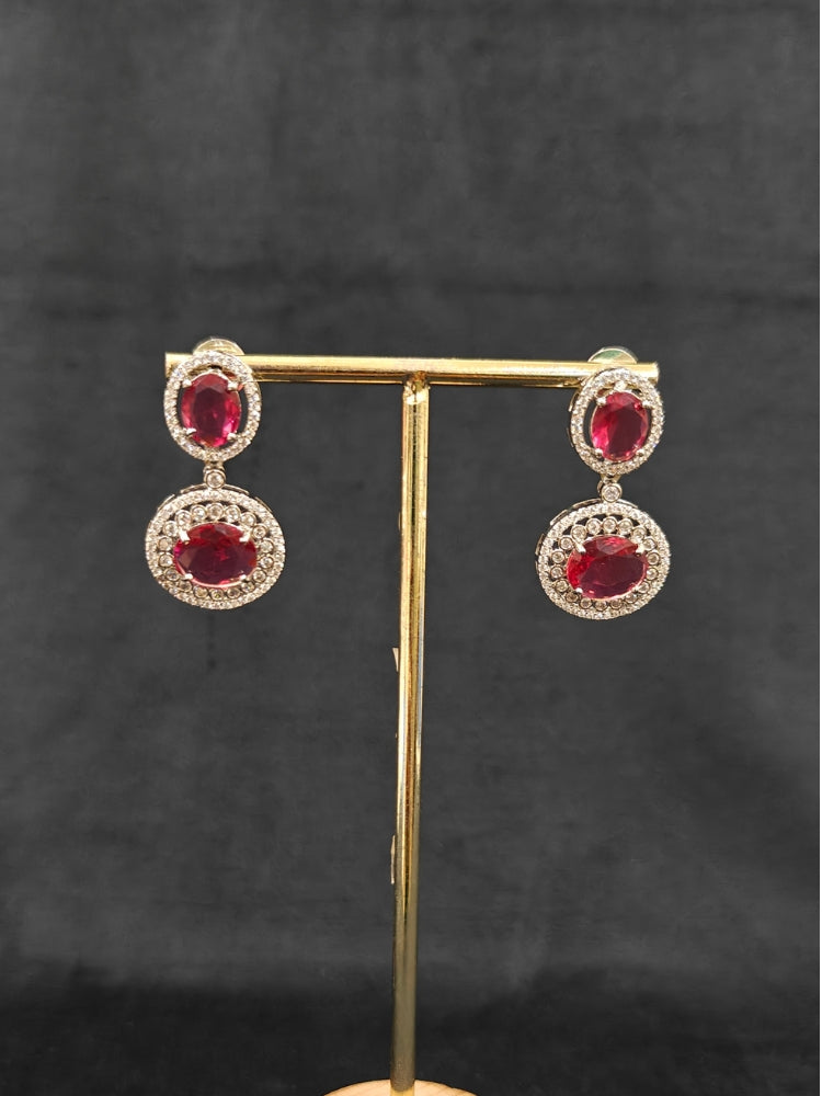 An elegant artificial diamond necklace with red colored stone and matching earrings. This premium artificial diamond jewelry set is perfect for special occasions, from Indian weddings to engagement parties, offering sophisticated glamour without the high price tag.