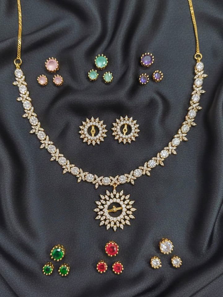 Close-up of an ornate Indo-western Multi-Color Changeable (Mehendi gold Polish) Collar jewellery set and earrings with American Diamond and Colored Stones. Party wear outfit completed with a lightweight American diamond necklace. Close-up shot of a high-quality American diamond artificial necklace worn for festive celebrations.