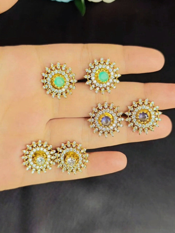 Close-up of an ornate Indo-western Multi-Color Changeable (Mehendi gold Polish) Collar jewellery set and earrings with American Diamond and Colored Stones. Party wear outfit completed with a lightweight American diamond necklace. Close-up shot of a high-quality American diamond artificial necklace worn for festive celebrations.