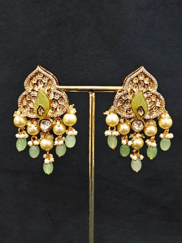 Close-up of an ornate traditional (Gold Polish) Mint Green Long jewellery set and earrings with Polki, American Diamond Tumble Beads and Pearls. Woman wearing trending Polki artificial jewelry for the wedding season in India. Wedding guest outfit styled with an elegant Polki necklace set.