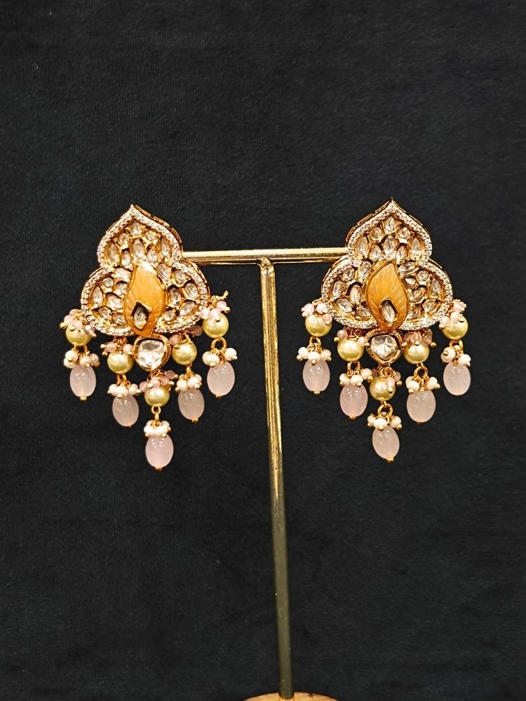 Close-up of an ornate traditional (Gold Polish) Mint Pink Long jewellery set and earrings with Polki, American Diamond Tumble Beads and Pearls. Woman wearing trending Polki artificial jewelry for the wedding season in India. Wedding guest outfit styled with an elegant Polki necklace set.