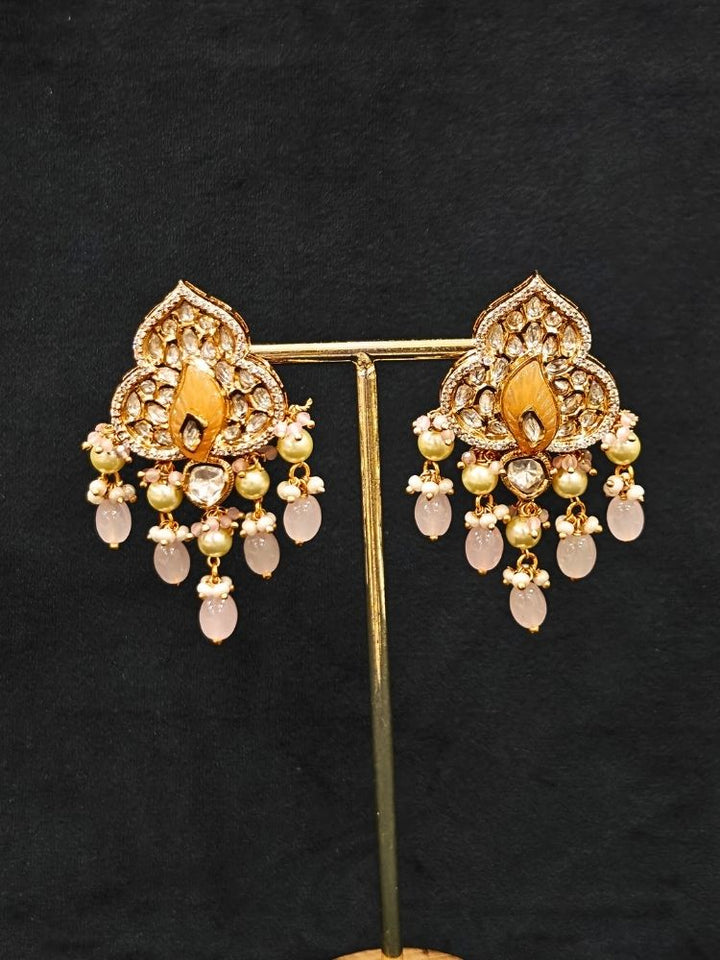Close-up of an ornate traditional (Gold Polish) Mint Pink Long jewellery set and earrings with Polki, American Diamond Tumble Beads and Pearls. Woman wearing trending Polki artificial jewelry for the wedding season in India. Wedding guest outfit styled with an elegant Polki necklace set.