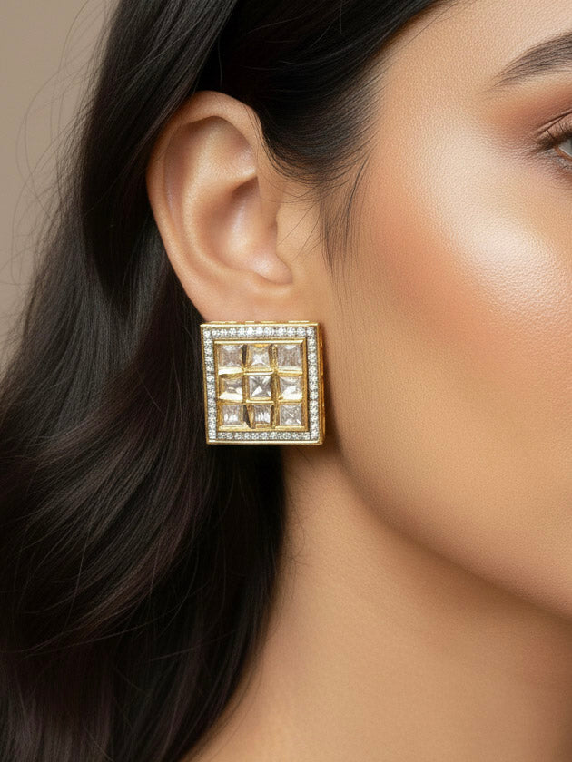 Close-up of a woman wearing an ornate traditional Kundan (gold polish) Studs Earrings with American Diamond and Kundan. Mehendi function outfit styled with a lightweight Kundan Studs Earrings. Saree look enhanced with a traditional  artificial Kundan Earrings.
