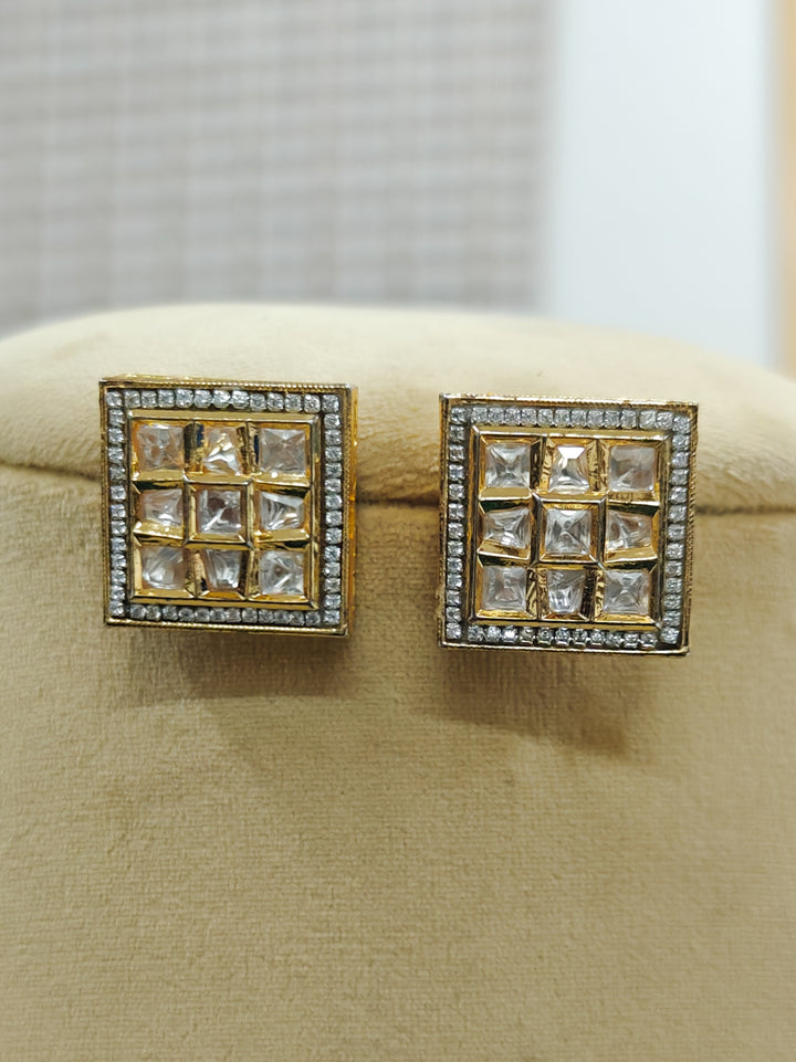 Close-up of an ornate traditional Kundan (gold polish) Studs Earrings with American Diamond and Kundan. Mehendi function outfit styled with a lightweight Kundan Studs Earrings. Saree look enhanced with a traditional  artificial Kundan Earrings.