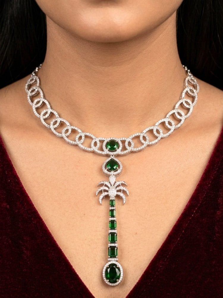 Close-up of a woman wearing an ornate Western (Silver Polish) Collar jewellery set and earrings with American Diamond and Green Colored Stones. Party wear outfit completed with a lightweight American diamond necklace. Model wearing a lightweight American diamond necklace perfect for long wedding functions.
Close-up of a bridal look featuring an anti-tarnish American diamond artificial necklace.