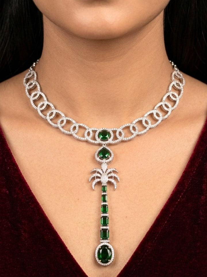 Close-up of a woman wearing an ornate Western (Silver Polish) Collar jewellery set and earrings with American Diamond and Green Colored Stones. Party wear outfit completed with a lightweight American diamond necklace. Model wearing a lightweight American diamond necklace perfect for long wedding functions.
Close-up of a bridal look featuring an anti-tarnish American diamond artificial necklace.
