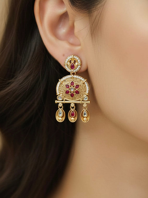 Close-up of a woman wearing an ornate traditional Rajwadi gold Long jewellery set and earrings  with  Pearls, Beads, Colored Stones, Bandhai Work and Kundan. Close-up of a Rajwadi artificial necklace for wedding celebrations. Mehendi ceremony look styled with a Rajwadi artificial jewelry set.