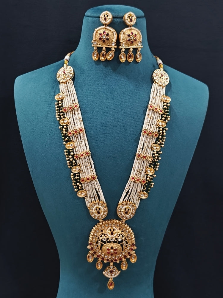 Close-up of an ornate traditional Rajwadi gold Long jewellery set and earrings  with  Pearls, Beads, Colored Stones, Bandhai Work and Kundan. Close-up of a Rajwadi artificial necklace for wedding celebrations. Close-up of a premium Rajwadi artificial necklace under 10000. 