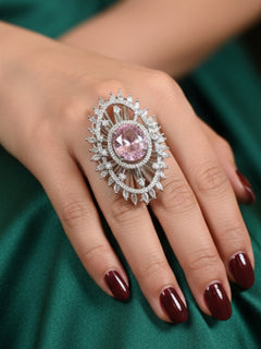 Close-up of a woman wearing an ornate Western (Silver Polish) Pink Diamond Ring with American Diamond and Colored Stones. Cocktail party outfit paired with sparkling artificial American Diamond Ring. Close-up of American diamond Ring styled for a reception party.