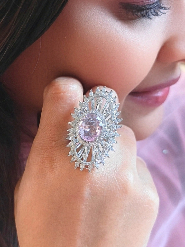 Close-up of a woman wearing an ornate Western (Silver Polish) Pink Diamond Ring with American Diamond and Colored Stones. Cocktail party outfit paired with sparkling artificial American Diamond Ring. Close-up of American diamond Ring styled for a reception party.