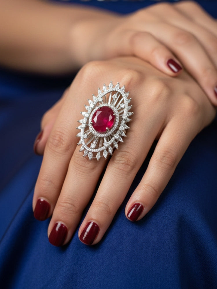 Close-up of a woman wearing an ornate Western (Silver Polish) Red Diamond Ring with American Diamond and Colored Stones. Cocktail party outfit paired with sparkling artificial American Diamond Ring. Close-up of American diamond Ring styled for a reception party.
