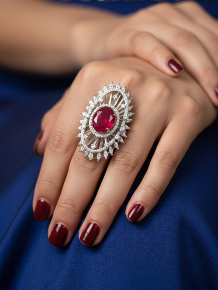 Close-up of a woman wearing an ornate Western (Silver Polish) Red Diamond Ring with American Diamond and Colored Stones. Cocktail party outfit paired with sparkling artificial American Diamond Ring. Close-up of American diamond Ring styled for a reception party.
