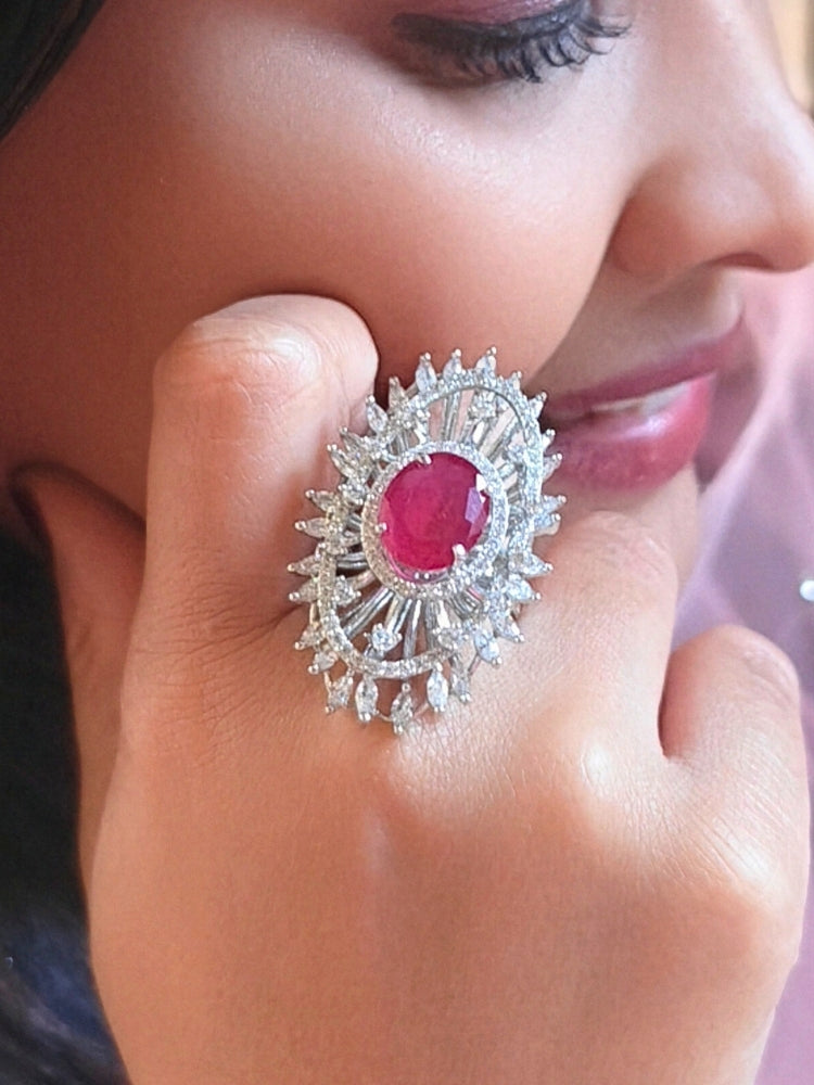Close-up of a woman wearing an ornate Western (Silver Polish) Red Diamond Ring with American Diamond and Colored Stones. Cocktail party outfit paired with sparkling artificial American Diamond Ring. Close-up of American diamond Ring styled for a reception party.