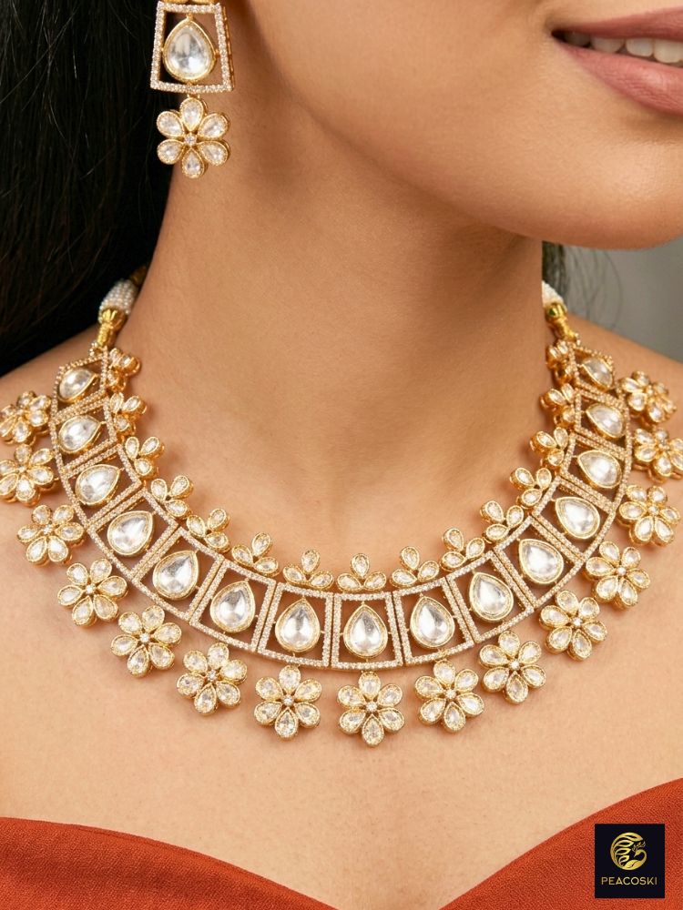 Close-up of a woman wearing an ornate traditional (Gold Polish) White Collar jewellery set and earrings with Polki and American Diamond. Reception-ready look featuring a sparkling Polki necklace set. Close-up of a cocktail party look featuring a premium American diamond necklace.
