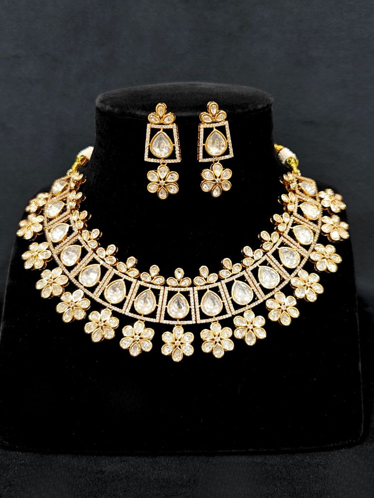 Close-up of an ornate traditional (Gold Polish) White Collar jewellery set and earrings with Polki and American Diamond. Reception-ready look featuring a sparkling Polki necklace set. Close-up of a cocktail party look featuring a premium American diamond necklace.