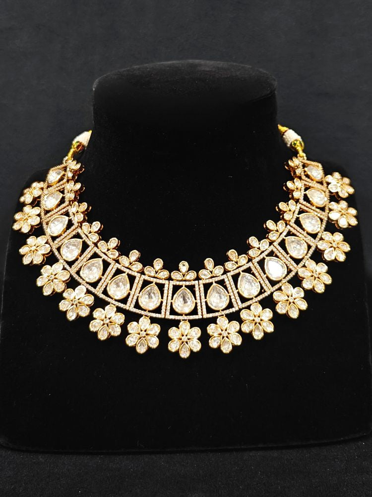 Close-up of an ornate traditional (Gold Polish) White Collar jewellery set and earrings with Polki and American Diamond. Reception-ready look featuring a sparkling Polki necklace set. Close-up of a cocktail party look featuring a premium American diamond necklace.