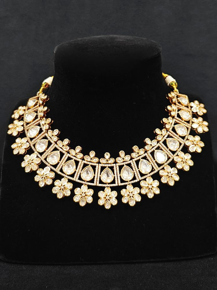 Close-up of an ornate traditional (Gold Polish) White Collar jewellery set and earrings with Polki and American Diamond. Reception-ready look featuring a sparkling Polki necklace set. Close-up of a cocktail party look featuring a premium American diamond necklace.