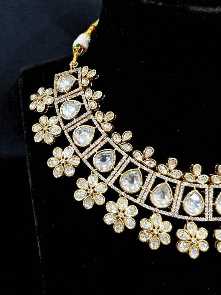 Close-up of an ornate traditional (Gold Polish) White Collar jewellery set and earrings with Polki and American Diamond. Reception-ready look featuring a sparkling Polki necklace set. Close-up of a cocktail party look featuring a premium American diamond necklace.