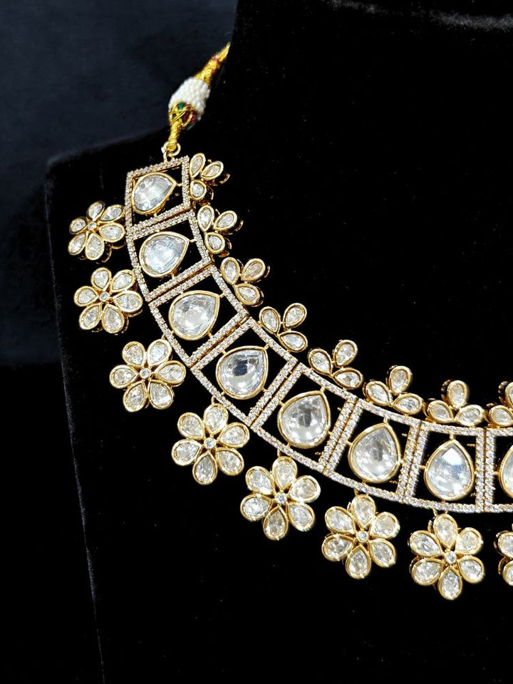 Close-up of an ornate traditional (Gold Polish) White Collar jewellery set and earrings with Polki and American Diamond. Reception-ready look featuring a sparkling Polki necklace set. Close-up of a cocktail party look featuring a premium American diamond necklace.