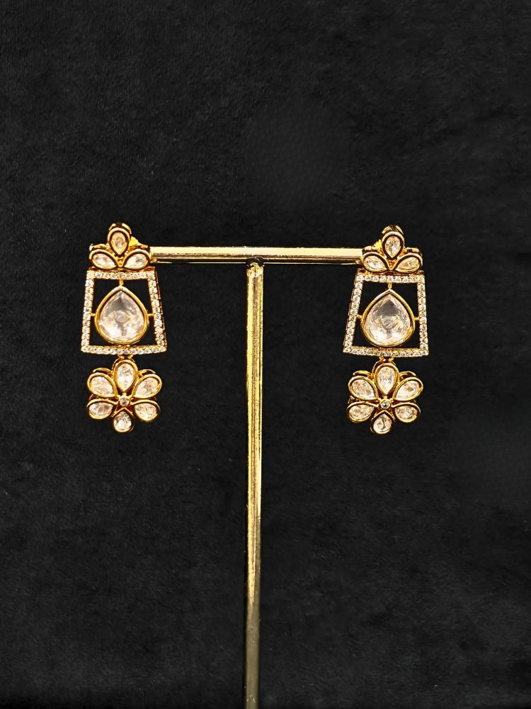 Close-up of an ornate traditional (Gold Polish) White Collar jewellery set and earrings with Polki and American Diamond. Reception-ready look featuring a sparkling Polki necklace set. Close-up of a cocktail party look featuring a premium American diamond necklace.