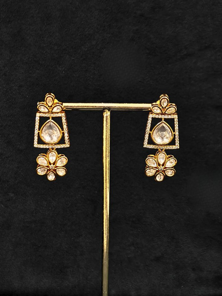 Close-up of an ornate traditional (Gold Polish) White Collar jewellery set and earrings with Polki and American Diamond. Reception-ready look featuring a sparkling Polki necklace set. Close-up of a cocktail party look featuring a premium American diamond necklace.